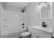 Modern bathroom with shower-tub combo, updated sink, and lighting at 1844 Brier Ln, Graham, NC 27253
