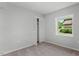 This bedroom features neutral walls, carpet, and a bright window with closet at 1844 Brier Ln, Graham, NC 27253