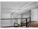 Bright foyer features hardwood flooring, a modern light fixture, and staircase with stylish black metal railings at 1844 Brier Ln, Graham, NC 27253