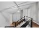 Inviting foyer features modern light fixture, wooden floors, and staircase with stylish black metal railings at 1844 Brier Ln, Graham, NC 27253