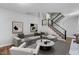 Inviting living room with hardwood floors, modern décor, and staircase access to the second floor at 1844 Brier Ln, Graham, NC 27253