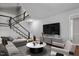 Bright living room featuring hardwood floors, a comfortable couch, and staircase to the second floor at 1844 Brier Ln, Graham, NC 27253