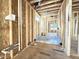 Partially framed bathroom featuring exposed studs, electrical wiring, plumbing, and piping for radiant flooring at 2728 Trifle Ln, Wake Forest, NC 27587