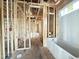 Partially framed bathroom featuring exposed studs, electrical wiring, plumbing, and a new white bathtub at 2728 Trifle Ln, Wake Forest, NC 27587