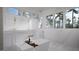 Luxurious bathroom with a soaking tub, double vanity, marble floors, and large windows for natural light at 2728 Trifle Ln, Wake Forest, NC 27587