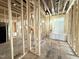 Unfinished bathroom showing exposed framing, wood subfloor, and rough openings for plumbing and fixtures at 2728 Trifle Ln, Wake Forest, NC 27587