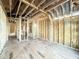 Unfinished bedroom showing exposed framing, wood subfloor, and rough openings for electrical and plumbing at 2728 Trifle Ln, Wake Forest, NC 27587