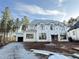 Two-story home under construction with large windows, gravel driveway, and frame showing at 2728 Trifle Ln, Wake Forest, NC 27587