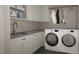 Well-organized laundry room with modern washer and dryer, plenty of counter space and storage cabinets at 2728 Trifle Ln, Wake Forest, NC 27587