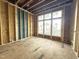 New living room is under construction with three large windows for plenty of natural light at 2728 Trifle Ln, Wake Forest, NC 27587