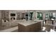 Modern living room featuring a fireplace, open shelving, kitchen island, and dining area at 2728 Trifle Ln, Wake Forest, NC 27587