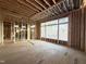 This new living room is under construction with large windows overlooking a wooded area at 2728 Trifle Ln, Wake Forest, NC 27587