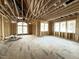 Spacious living room featuring wood-framed walls, exposed beams, and ample natural light from multiple windows at 2728 Trifle Ln, Wake Forest, NC 27587