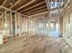 Unfinished living room showing exposed framing and wood subfloor at 2728 Trifle Ln, Wake Forest, NC 27587