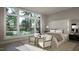 Bright main bedroom with large windows offering a great view, hardwood floors, and sitting area at 2728 Trifle Ln, Wake Forest, NC 27587