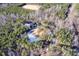 Aerial view highlighting home's private setting in wooded area with a long driveway at 406 Terry Rd, Hillsborough, NC 27278