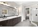 Primary bathroom with double vanity, large mirror, and walk-in shower at 406 Terry Rd, Hillsborough, NC 27278