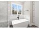 Bathroom with soaking tub, walk-in shower, and window at 406 Terry Rd, Hillsborough, NC 27278