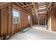 Unfinished bedroom with wood framing, new windows and flooring at 406 Terry Rd, Hillsborough, NC 27278