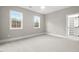 Bright bedroom featuring carpet, large windows and a walk-in closet at 406 Terry Rd, Hillsborough, NC 27278