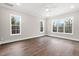 Spacious bedroom with hardwood floors and multiple windows at 406 Terry Rd, Hillsborough, NC 27278
