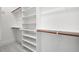 Bright walk-in closet with white shelves and hanging rods at 406 Terry Rd, Hillsborough, NC 27278