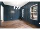 Spacious dining room features dark blue walls, hardwood floors and large windows at 406 Terry Rd, Hillsborough, NC 27278