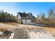 Home exterior, three-car garage, and long driveway at 406 Terry Rd, Hillsborough, NC 27278