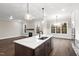 Island kitchen with marble countertops and stainless steel appliances at 406 Terry Rd, Hillsborough, NC 27278