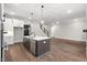 Modern kitchen with island, stainless steel appliances, and hardwood floors at 406 Terry Rd, Hillsborough, NC 27278