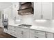 Modern kitchen features white cabinets, marble countertops and a gas cooktop at 406 Terry Rd, Hillsborough, NC 27278