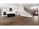 Spacious living area with hardwood floors, kitchen, and staircase at 406 Terry Rd, Hillsborough, NC 27278