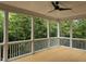 Spacious screened porch with wood flooring and wooded views at 406 Terry Rd, Hillsborough, NC 27278