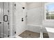 Luxurious shower with glass enclosure, tiled walls, and built-in seat at 406 Terry Rd, Hillsborough, NC 27278