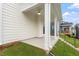 Relaxing covered back patio has white columns, a ceiling fan, and a view of the backyard and surrounding homes at 9249 Kitchin Farms Way # 432, Wake Forest, NC 27587