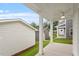 This covered back patio features white columns and a ceiling fan for ultimate outdoor relaxation at 9249 Kitchin Farms Way # 432, Wake Forest, NC 27587