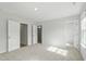 Spacious bedroom with plush carpeting and doors to ensuite bathroom and closet at 9249 Kitchin Farms Way # 432, Wake Forest, NC 27587