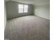 Spacious bonus room with carpeting, natural light, and a storage door at 9249 Kitchin Farms Way # 432, Wake Forest, NC 27587