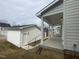 A view of the home's backyard, featuring a well-manicured lawn and detached garage at 9249 Kitchin Farms Way # 432, Wake Forest, NC 27587