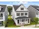 Charming two-story home features a covered front porch, black shutters, and a well-manicured front lawn at 9249 Kitchin Farms Way # 432, Wake Forest, NC 27587