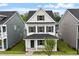 Beautiful two-story home boasts a classic design, neat landscaping, and a cozy covered front porch at 9249 Kitchin Farms Way # 432, Wake Forest, NC 27587