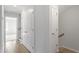 Hallway featuring wood-look flooring, two closets, neutral paint, and white trim at 9249 Kitchin Farms Way # 432, Wake Forest, NC 27587