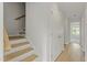 Hallway view with wooden stairs, a storage closet, and an open doorway at 9249 Kitchin Farms Way # 432, Wake Forest, NC 27587