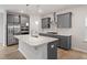 Modern kitchen featuring gray cabinets, stainless steel appliances, and a large center island at 9249 Kitchin Farms Way # 432, Wake Forest, NC 27587