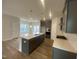 The kitchen features stainless steel appliances, a central island, and modern finishes at 9249 Kitchin Farms Way # 432, Wake Forest, NC 27587