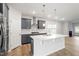 Modern kitchen with stainless steel appliances, island with quartz countertop, gray cabinetry, and subway tile backsplash at 9249 Kitchin Farms Way # 432, Wake Forest, NC 27587