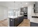 Bright kitchen with stainless steel appliances, gray cabinets, and an island with a sink and dishwasher at 9249 Kitchin Farms Way # 432, Wake Forest, NC 27587