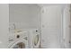Laundry room features white washer and dryer, wire shelving and white door at 9249 Kitchin Farms Way # 432, Wake Forest, NC 27587