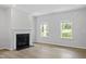 Fireplace in a living area with hardwood floors, white trim, and two windows allowing natural light at 9249 Kitchin Farms Way # 432, Wake Forest, NC 27587