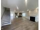 This spacious living room features hardwood floors and a cozy fireplace at 9249 Kitchin Farms Way # 432, Wake Forest, NC 27587